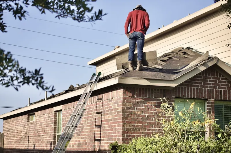 Professional roofer working on a residential roof in Wrigley Park